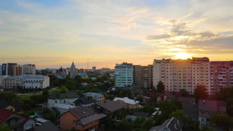 aerial view of high rise apartment buildings, private houses and streets in city residential area in evening