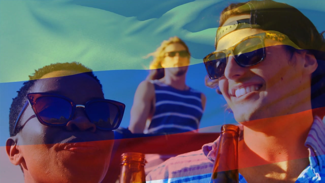 Composite video of waving colombia flag over group of diverse friends toasting beers outdoors