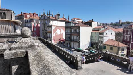 people enjoy a sunny day overlooking porto's waterfront with views of boats and buildings