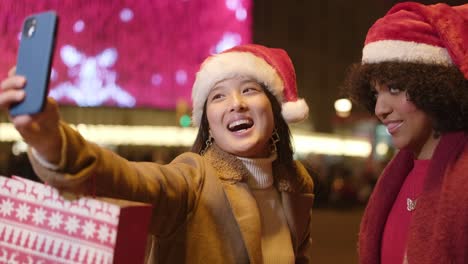 friends taking christmas selfies