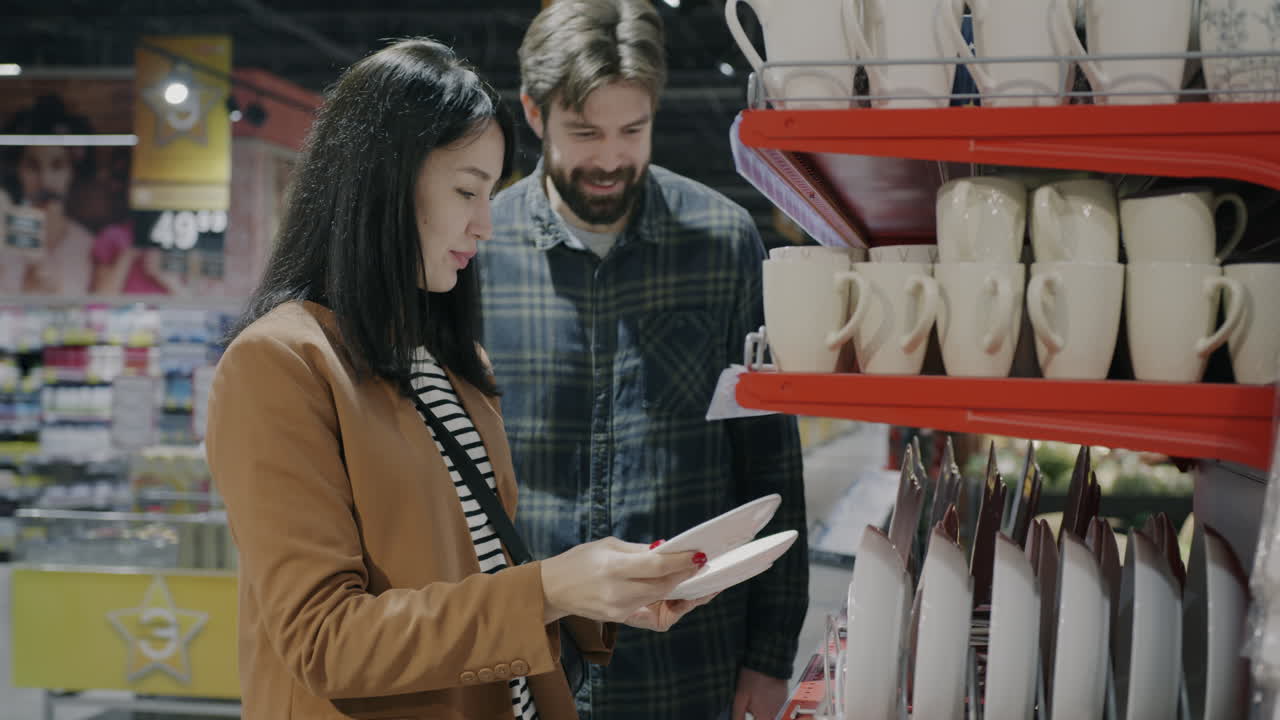 Couple Shopping for Dishes in a Supermarket