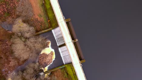 aerial birds eye view over road on encoro de villasenin reservoir