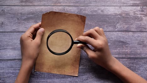 hand in magnifying glass inspecting 404 error