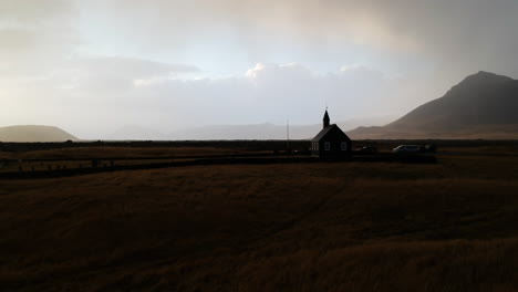 isolated catholic church in landscape of icelandic highland, drone aerial view. silhouette of building and scenic nature