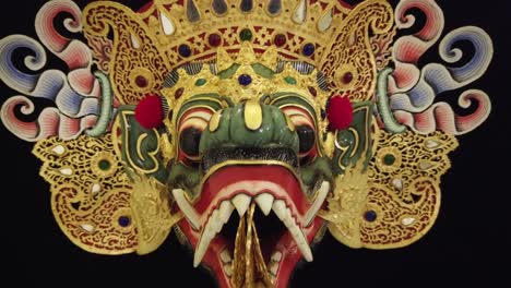 wood carved mask of royal crocodile, topeng dance cultural tradition in bali indonesia, black infinite background