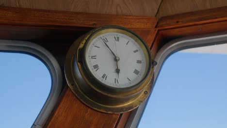 old vintage gold clock on a boat that tells the time at 5:55 pm slowmotion