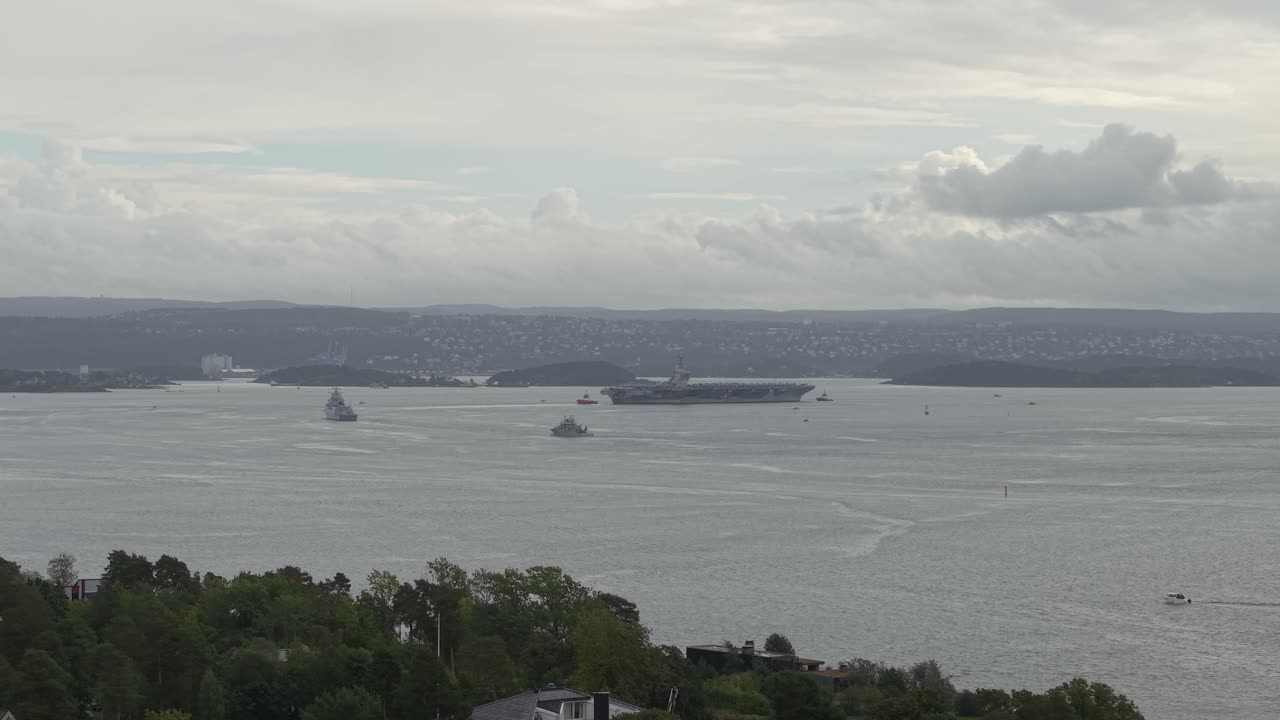 US Navy USS Gerald R. Ford (CVN-78) Aircraft Carrier Navigating in Oslo Fjord In Oslo, Norway. - aerial shot