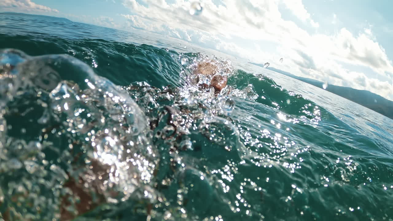 Man swimming in the Aegean sea. Slow motion, underwater shooting. Greece