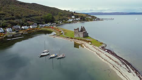 Aerial-view-of-Lochranza-Castle-on-the-Isle-of-Arran-on-an-overcast-day,-Scotland