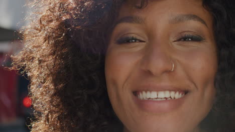 Portrait-happy-african-american-woman-smiling-in-city