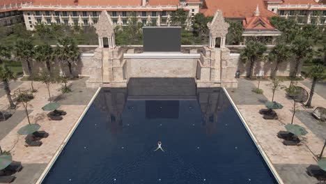 Woman-swims-alone-in-giant-pool-at-Sohka-Reap-Resort-in-Cambodia