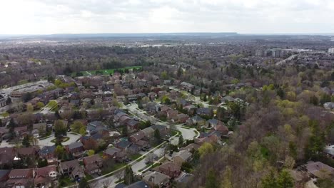 drone flying up and away from an oakville suburb during spring time