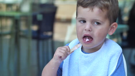 gimbal shot of toddler eating strawberry ice cream