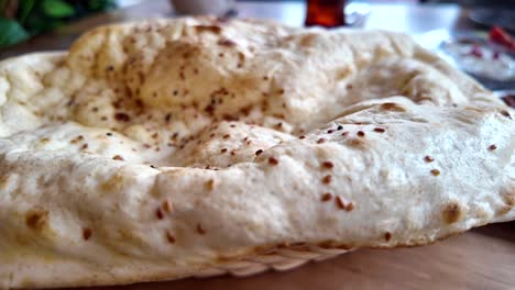 close-up of a traditional flatbread with sesame seeds