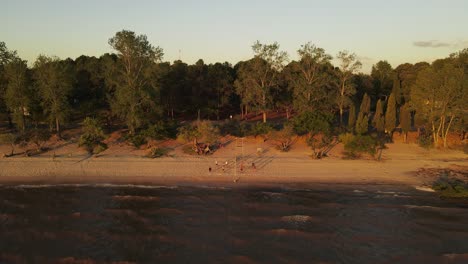 Slow-Motion-Shot-Of-Friends-Playing-Volley-Ball-On-Fray-Bentos-Coast,-Uruguay