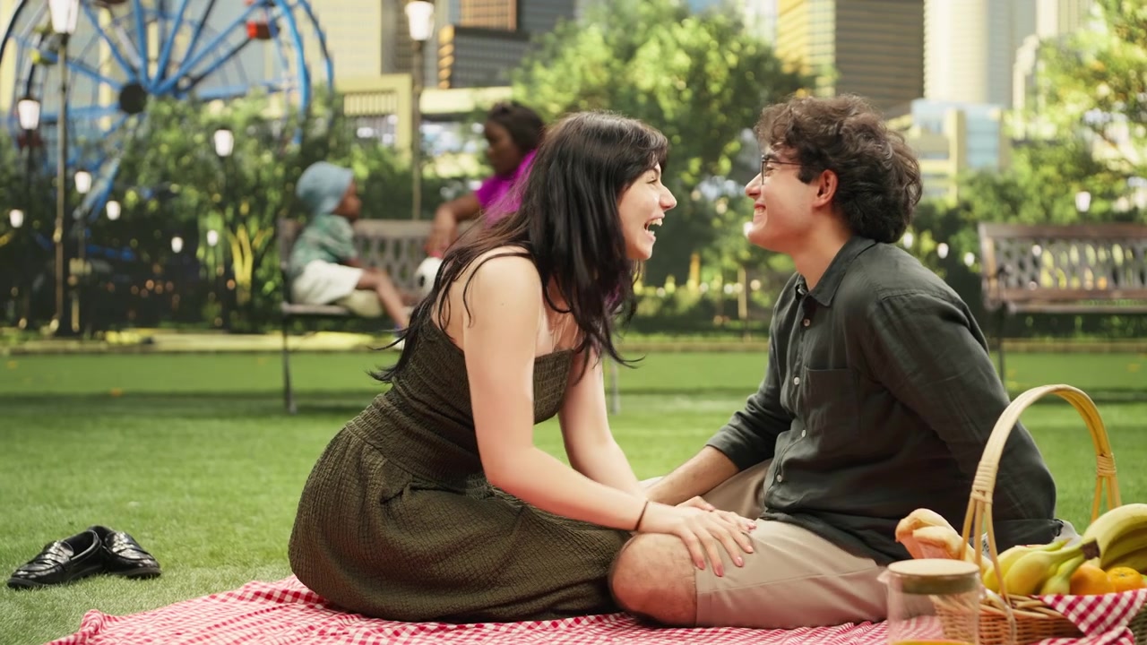 Young couple sitting together and talking on romantic picnic date