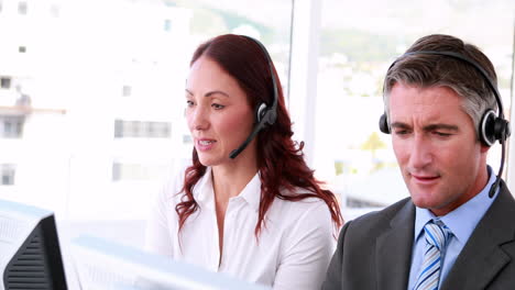 Call-centre-agents-working-and-talking-on-headsets