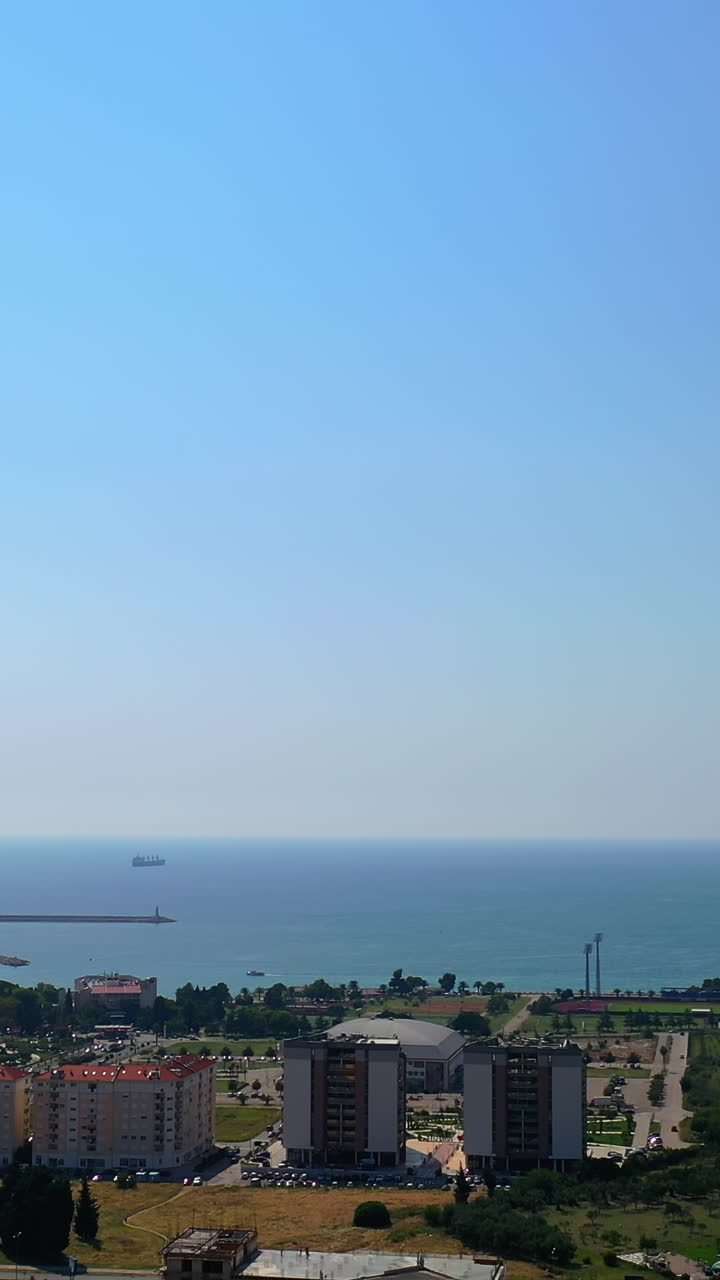 Top view panorama of sunny city of Bar in Montenegro. Splendid scenery of the Adriatic Sea at backdrop. Vertical video