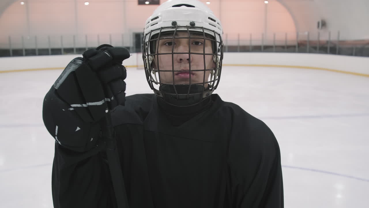 Portrait Of Male Hockey Player In Black Uniform