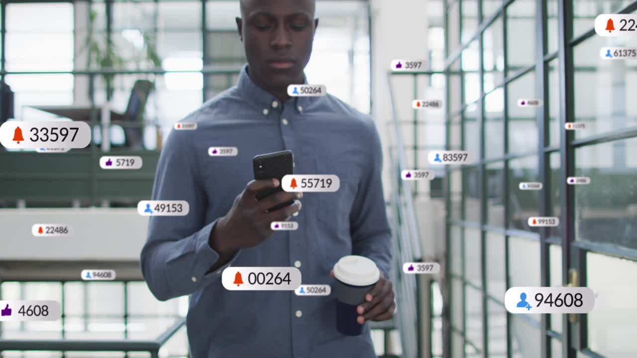 Animation of social media icons with numbers over african american businessman using smartphone