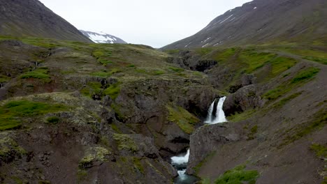 Waterfalls-flowing-and-stacked-in-Iceland-with-drone-video-moving-in-and-up