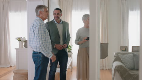 real estate agent showing mature couple new house presenting property investment happy clients shaking hands with realtor successfully purchasing home 4k footage