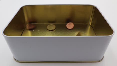 coins falling into a metallic little box