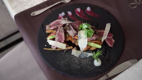 served roast beef on a black plate