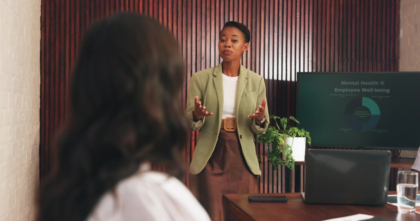 Professional Businesswoman Presenting Mental Health Strategy to Colleagues in Office