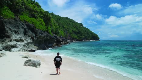 men on the beautiful beach in bali island, indonesia