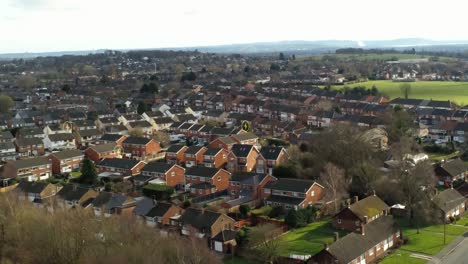 High-energy-consumption-homes-aerial-view-orbiting-British-neighbourhood-with-flashing-icon-overlay