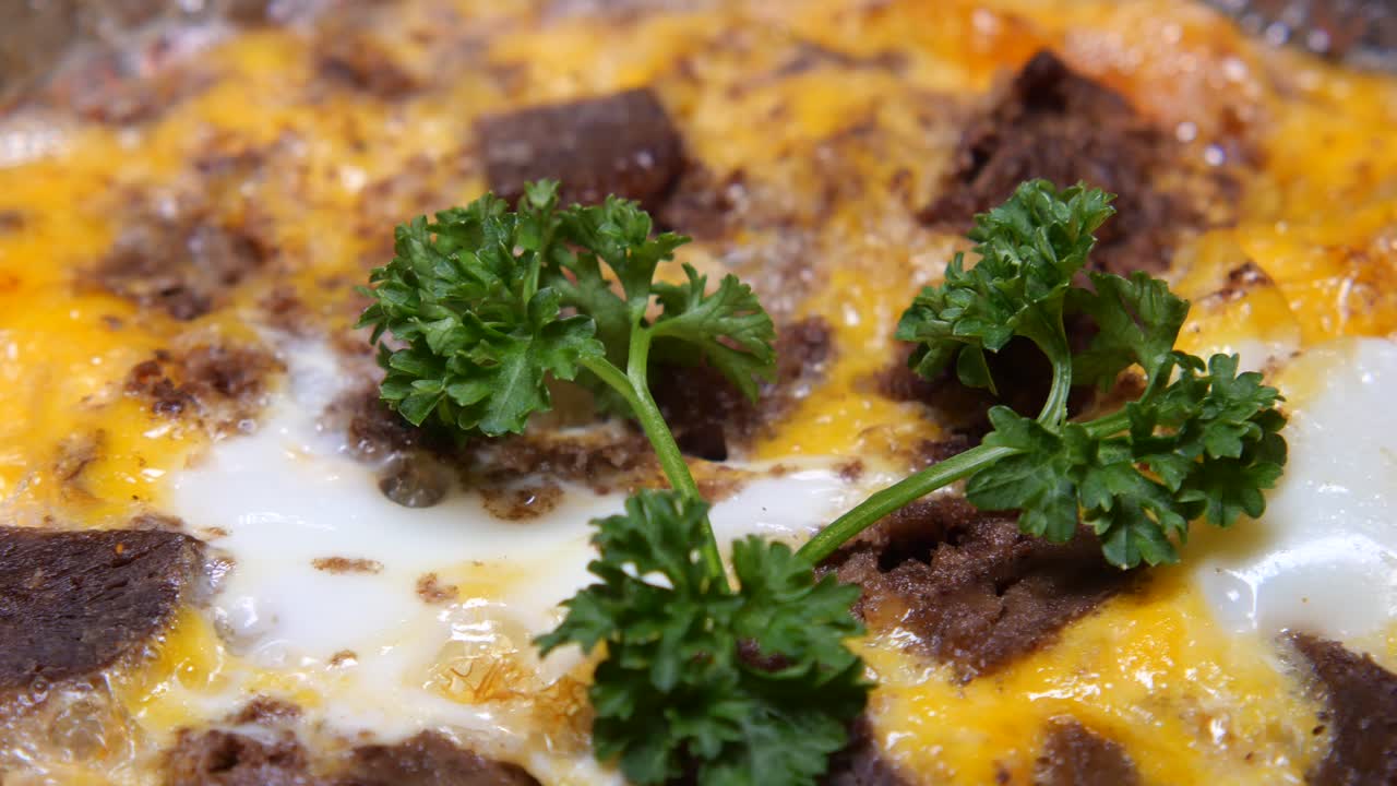 Close-up of a savory omelet with parsley and meat