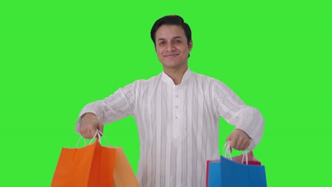hombre indio feliz con bolsas de compras pantalla verde