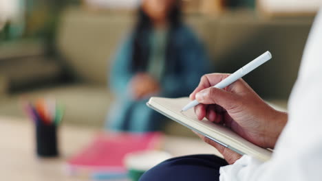 therapist taking notes during a session with a patient