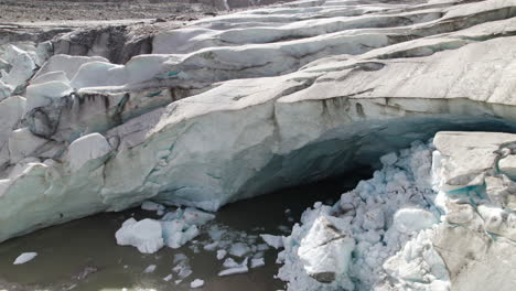 Aerial-closeup-of-Pasterze-glacier-melting-ice-cave-due-to-climate-change,-Retreating-glacier-of-Austrian-Alps,-Austria