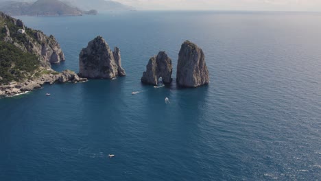 famous italy travel destination: faraglioni rocks on coast of capri, island - aerial