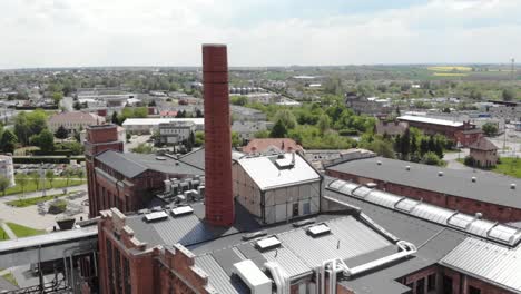 sugar factory building with smokestack in znin, poland