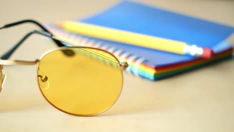 yellow sunglasses and notebook