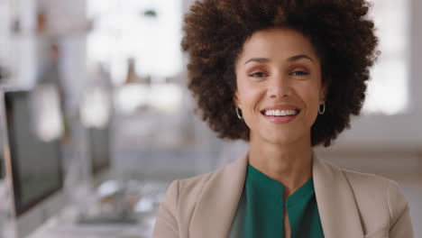 portrait-mixed-race-business-woman-with-afro-smiling-confident-entrepreneur-enjoying-successful-startup-company-proud-manager-in-office-workspace