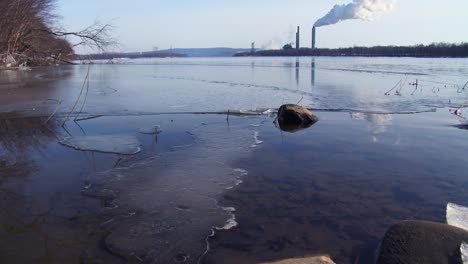 smoke rises from a distant power plant along a river 1