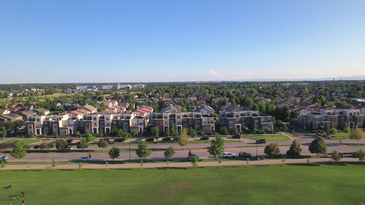 Aerial Drone flying parallel to houses in the Stapleton Suburb of the City of Denver, Colorado during golden hour in Summer