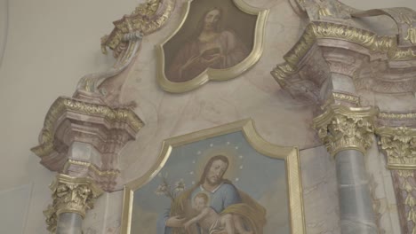 painting of st joseph with jesus in his arms on a baroque altar in a church