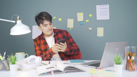 Male-student-using-phone-while-dancing.