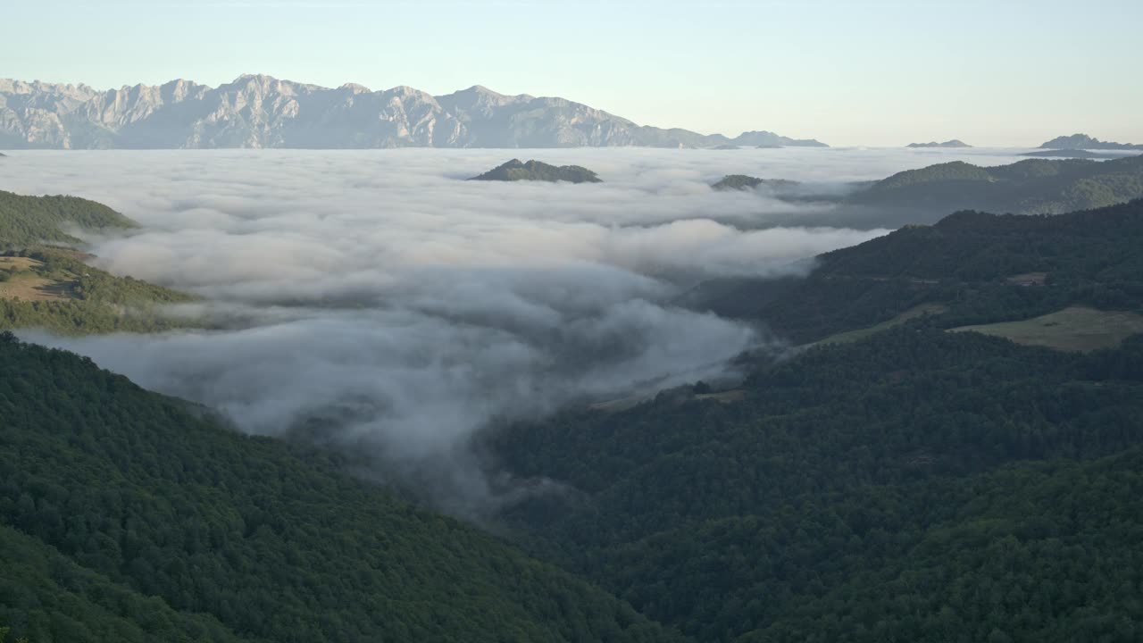 Long timelapse of disappearing sea of clouds during sunrise in the mountains. Cloud formation and atmospheric weather