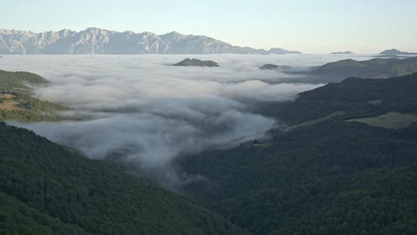 Long timelapse of disappearing sea of clouds during sunrise in the mountains. Cloud formation and atmospheric weather