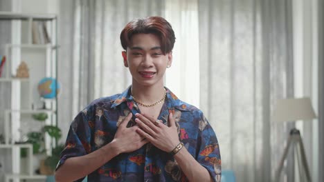 asian transgender male dancing while shooting video content for social networks at home