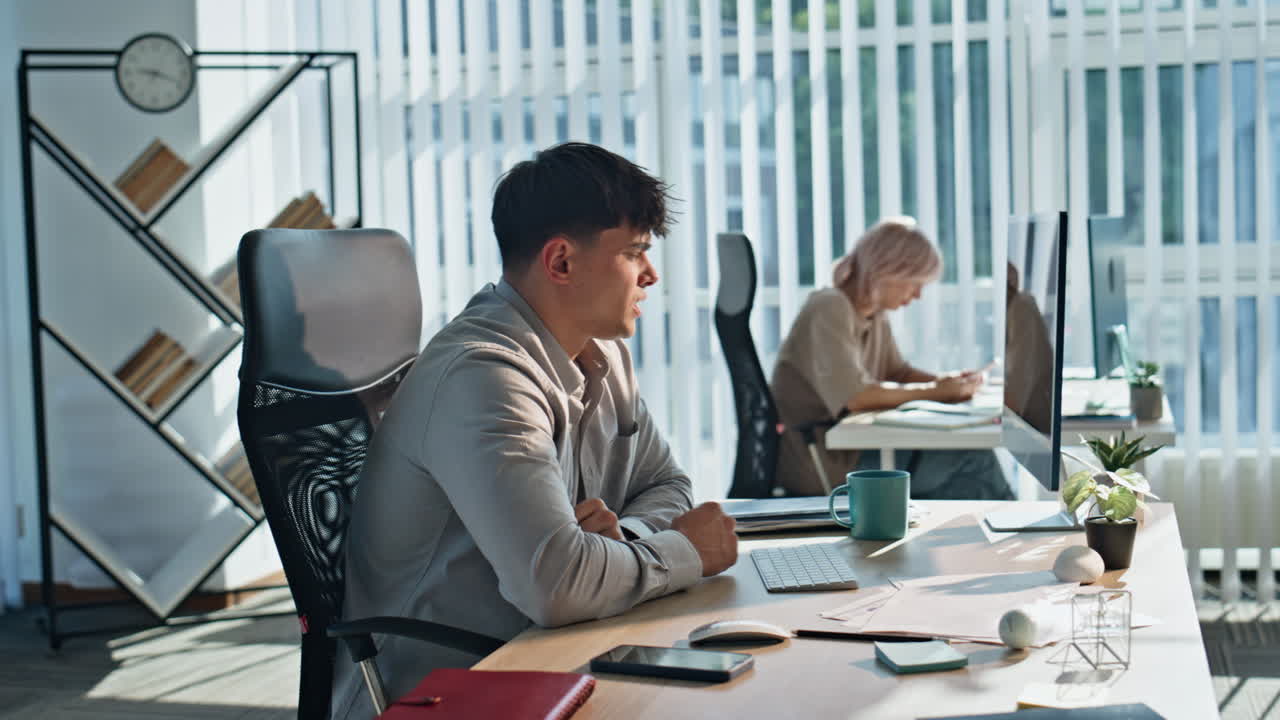 Exhausted worker rubbing eyes working open space closeup. Man looking computer