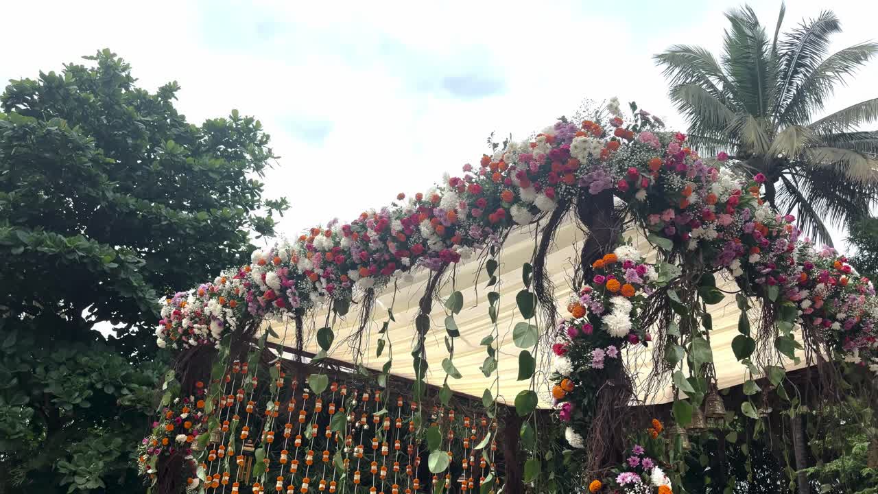 Decorative Colorful Flowers At A Gazebo During An Outdoor Hindu Wedding In Bengaluru, India. Low Angle Shot