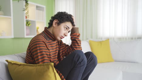 sad boy in the room. man's unhappy face.