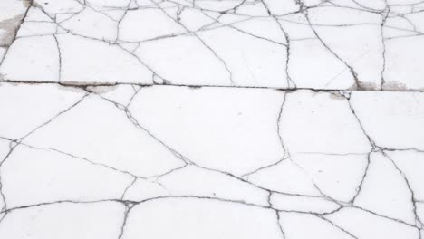 white marble floor with cracks